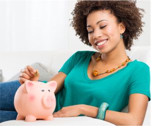 Young woman saving money with piggy bank